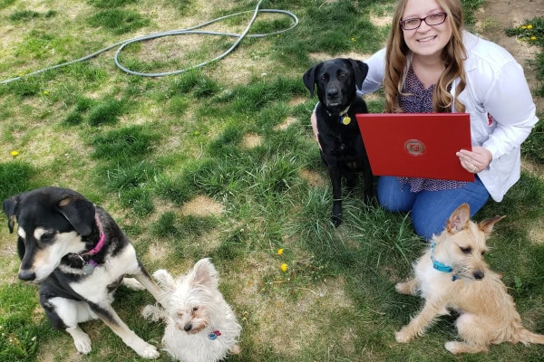 Dr. Harris with Dixie, her dog that was diagnosed with a brain tumor, and three other dogs