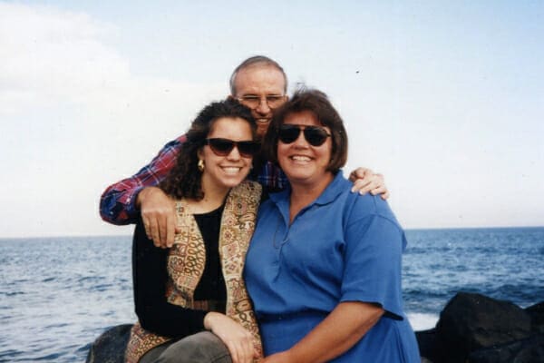 Dr. Buzby with her mother and father in front of the ocean, photo