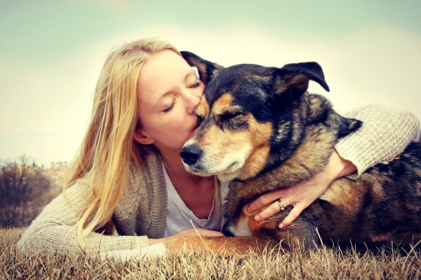 Young woman hugging her senior dog