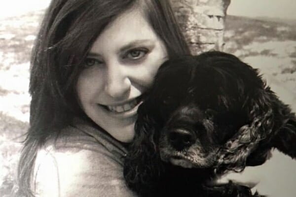 dog mom holding dog showing the happy times before she was grieving the loss of a dog after euthanasia, photo 