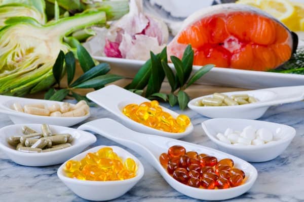 Various types of joint supplements in bowls on a table