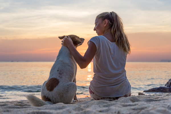 Owner with her dog on the beach