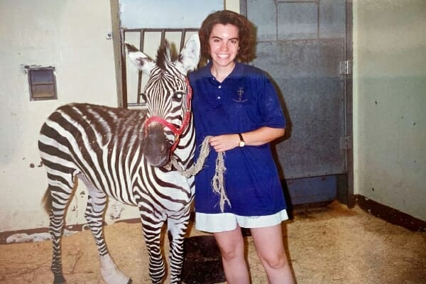 Vet student, Dr. Julie Buzby, and one of her first patients a zebra, photo