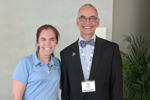 Veterinarian Julie Buzby and Dr. Harvey smiling for discussion about managing pain in dogs