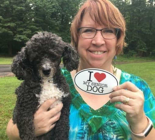 Robbi Hess, veterinary dog blog email coordinatory, standing outside with her beloved senior dog