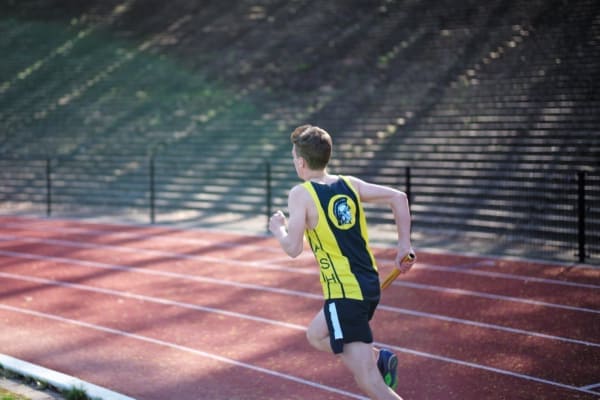 photo runner on track with a baton as an analogy of myasthenia gravis
